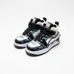Black and white Batman-themed high-top sneakers for kids with glowing bat logo, velcro straps, and comic-book inspired details.