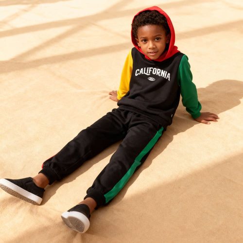 Black colorblock hoodie with “CALIFORNIA” graphic, red hood, yellow & green sleeves + matching black joggers with striped sides — sporty, bold outfit for boys.