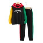 Black colorblock hoodie with “CALIFORNIA” graphic, red hood, yellow & green sleeves + matching black joggers with striped sides — sporty, bold outfit for boys.