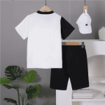 Black and white colorblock button-up shirt with gray stripe + matching black shorts — modern, minimalist outfit for boys.