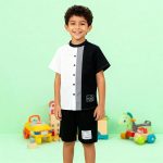 Black and white colorblock button-up shirt with gray stripe + matching black shorts — modern, minimalist outfit for boys.