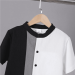 Black and white colorblock button-up shirt with gray stripe + matching black shorts — modern, minimalist outfit for boys.