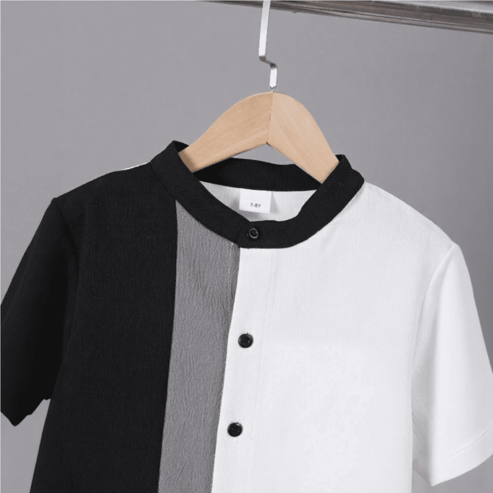 Black and white colorblock button-up shirt with gray stripe + matching black shorts — modern, minimalist outfit for boys.
