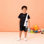 Black t-shirt with white diagonal panel, “future” script, and rose print + matching black shorts — edgy, modern outfit for boys or girls.