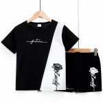 Black t-shirt with white diagonal panel, “future” script, and rose print + matching black shorts — edgy, modern outfit for boys or girls.