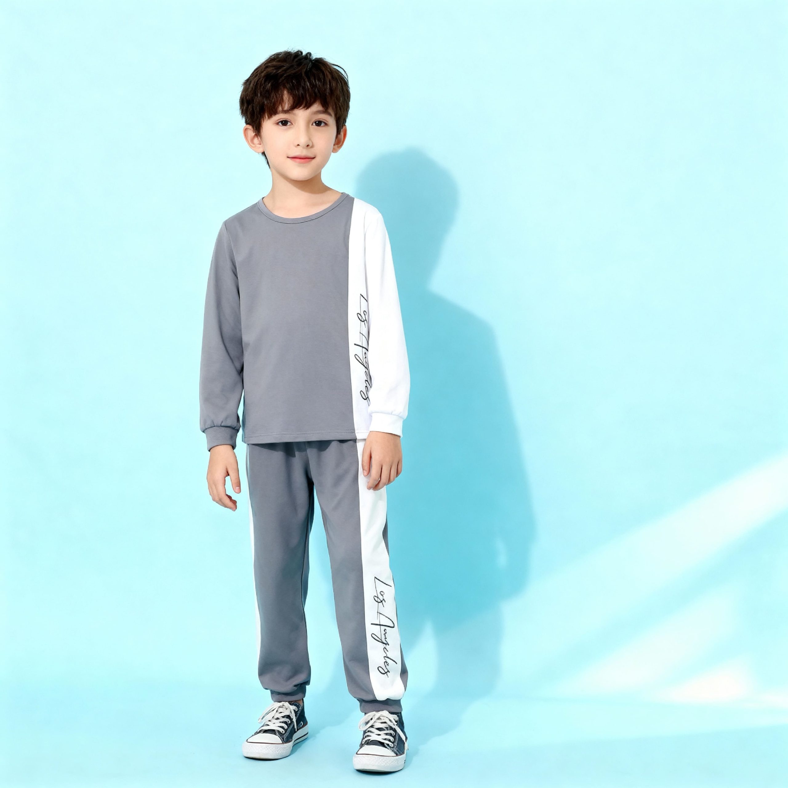 Gray long sleeve top and jogger pants with white side stripe and “Los Angeles” script — modern, minimalist outfit for boys or girls.