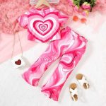 Bright pink swirl heart print t-shirt and flared pants set — bold, playful outfit for girls who love to stand out.