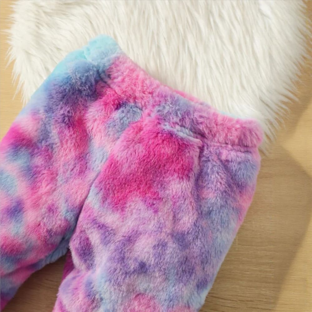 A vibrantly colored toddler girls' fuzzy loungewear bottom in tie-dye shades of pink, purple, and blue.