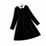 Black long-sleeve dress with white Peter Pan collar.