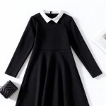 Black long-sleeve dress with white Peter Pan collar.