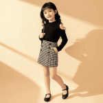 Black cold-shoulder knit top and houndstooth skirt dress