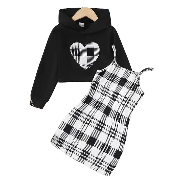 Girl wearing black hoodie with plaid heart and black-and-white plaid dress