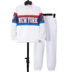 Boy in white quarter-zip top with “NEW YORK” print and white joggers