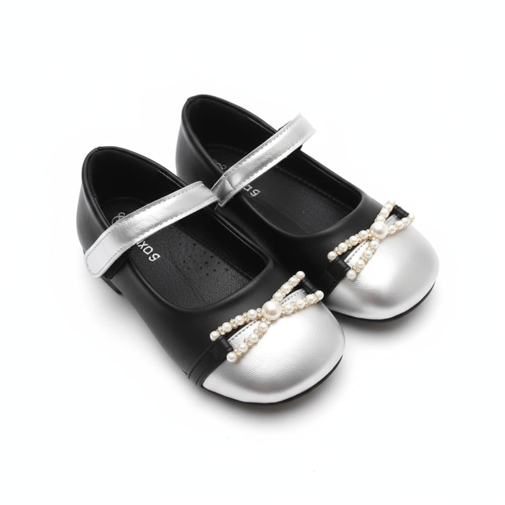 Girl’s black Mary Jane shoes with silver toe cap and pearl bow