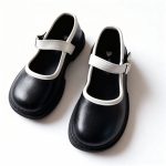 Girl’s black Mary Jane shoes with white trim and strap