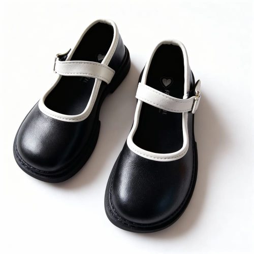 Girl’s black Mary Jane shoes with white trim and strap