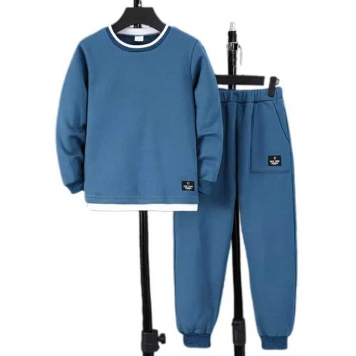 Boy in blue sweatshirt with white layered hem and matching joggers