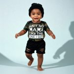 Camo bodysuit with “Ain’t No Mama Like The One I Got” + black shorts and hat