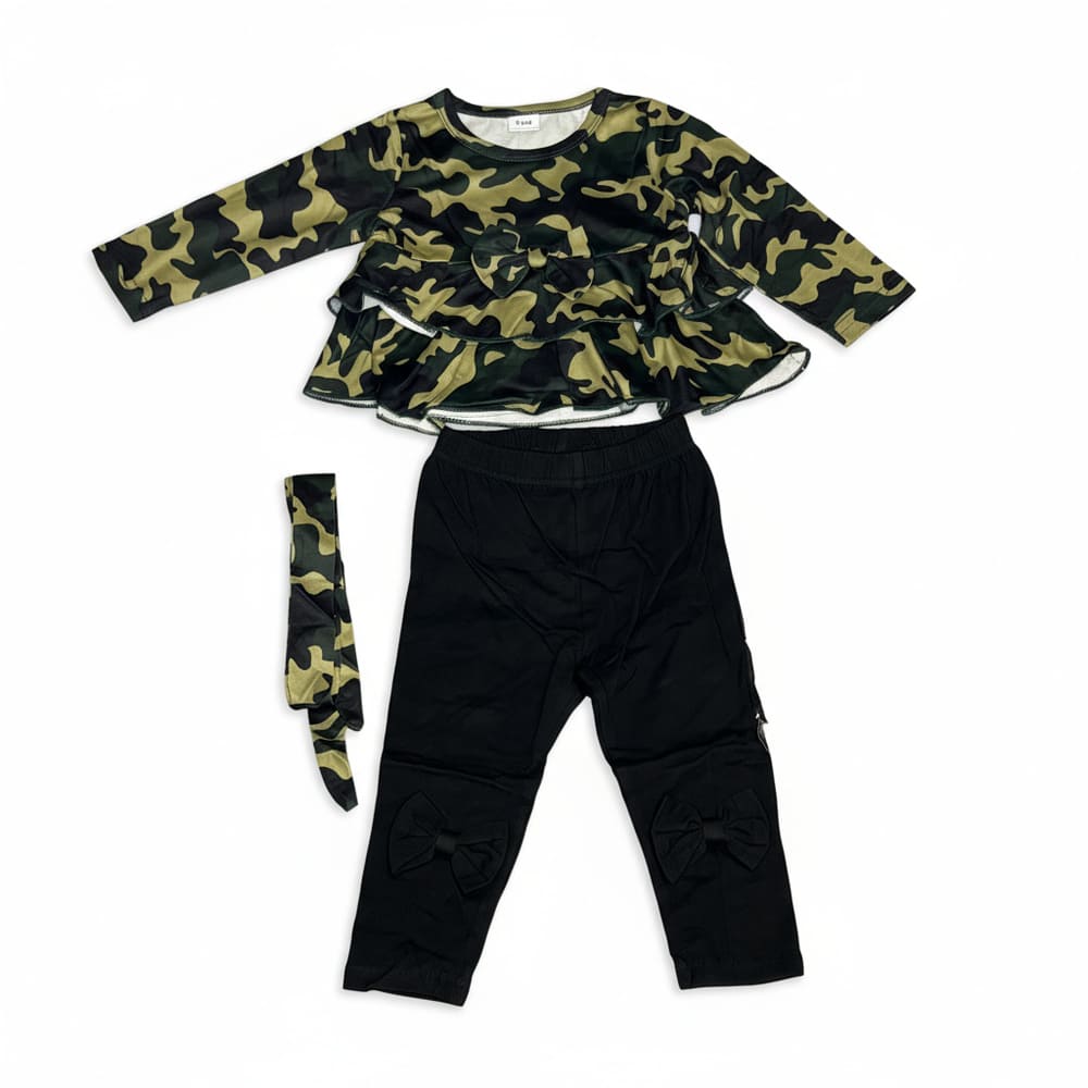 Girl wearing green camo ruffle top, black bow leggings, and matching headband