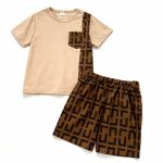 Boy wearing beige t-shirt with geometric pocket and matching patterned shorts