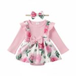 Girl wearing pink floral dress with bow and matching headband