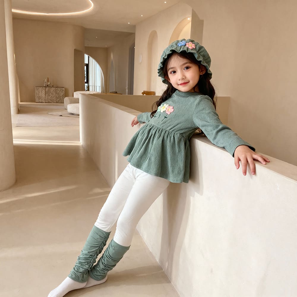 Sage green floral top and cream ruched pants