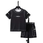Boy wearing black “Future” tee with stitch print and matching cargo shorts
