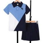 Boy wearing geometric polo with horse logo and navy shorts