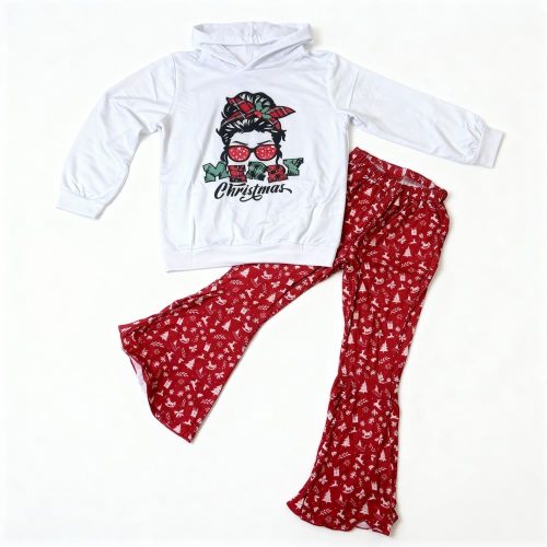 Girl wearing white “Merry Christmas” hoodie and red festive pants
