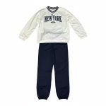 Boy in white v-neck “New York” sweatshirt and navy joggers