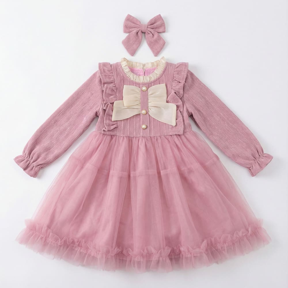 Girl wearing pink corduroy tutu dress with matching headband