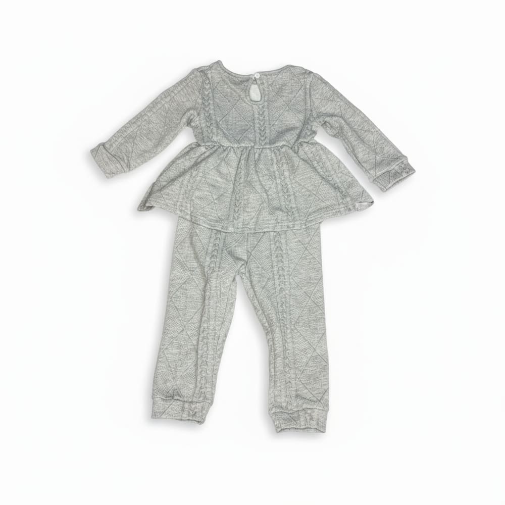 Girl wearing light gray quilted peplum top and matching pants