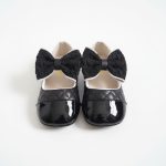 Girl’s cream quilted Mary Jane shoes with black toe cap and fluffy bow
