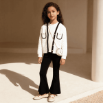 Girl wearing white quilted cardigan with black trim and black flare pants