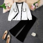 Girl wearing white quilted cardigan with black trim and black flare pants