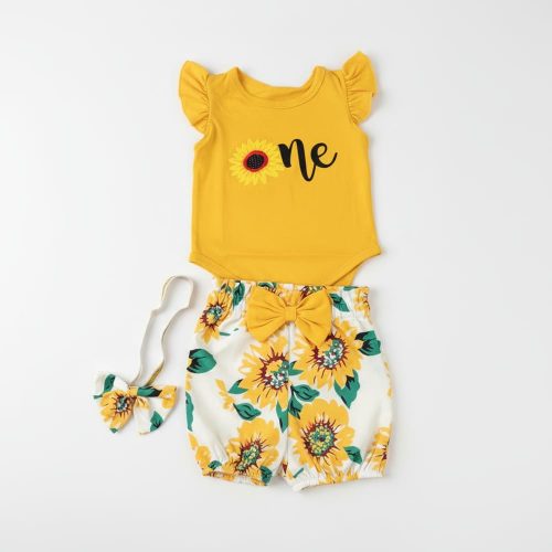Baby girl wearing yellow “one” bodysuit and sunflower shorts with headband