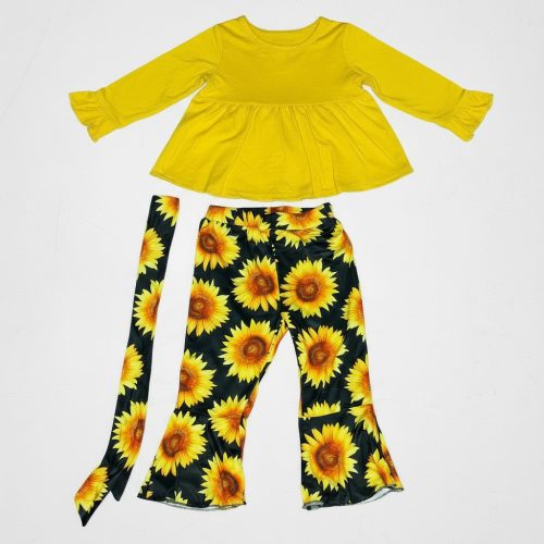 Girl wearing yellow ruffle top and black sunflower flare pants with tie