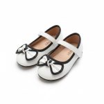 Girl’s white Mary Jane shoes with black-trimmed bow
