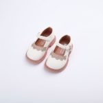 Girl’s white Mary Jane shoes with braided strap and scalloped toe