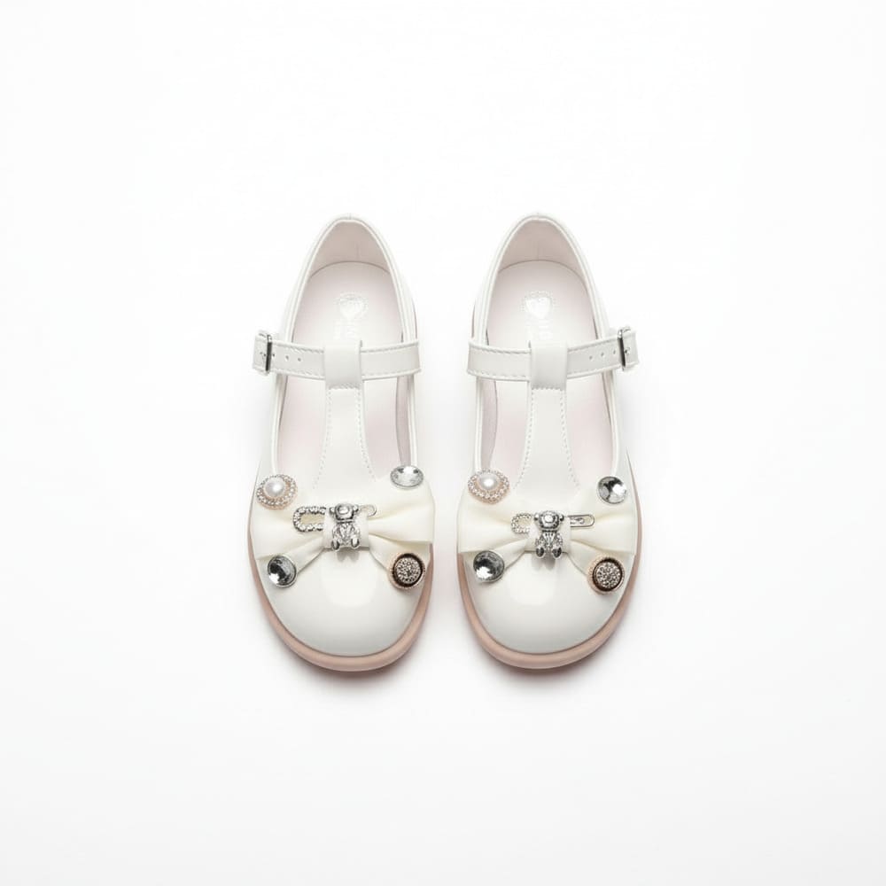 Girl’s white Mary Jane shoes with pearl bow and rhinestone details
