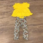Girl wearing yellow ruffle top and leopard butterfly pants